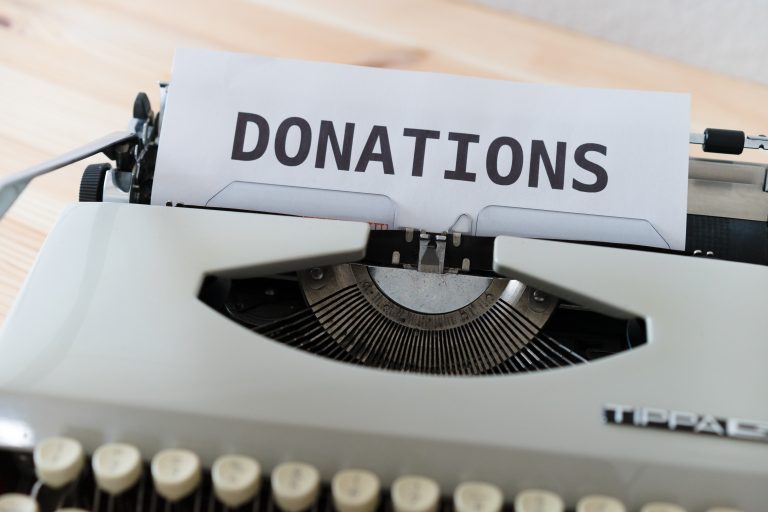 Paper saying "donations" in a typewriter