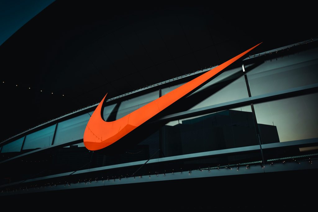 Orange Nike Swoosh logo on the side of a black building
